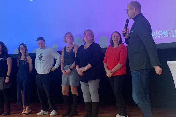 Ausgezeichnete Teampartner, inklusive Anita, stehen auf der Bühne und werden geehrt.